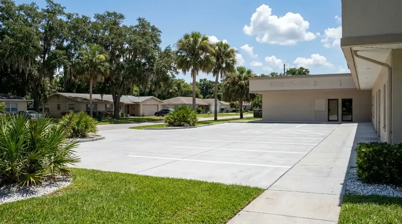 Concrete parking area and walkway beside a single-story commercial building, concrete work in Port Orange, FL
